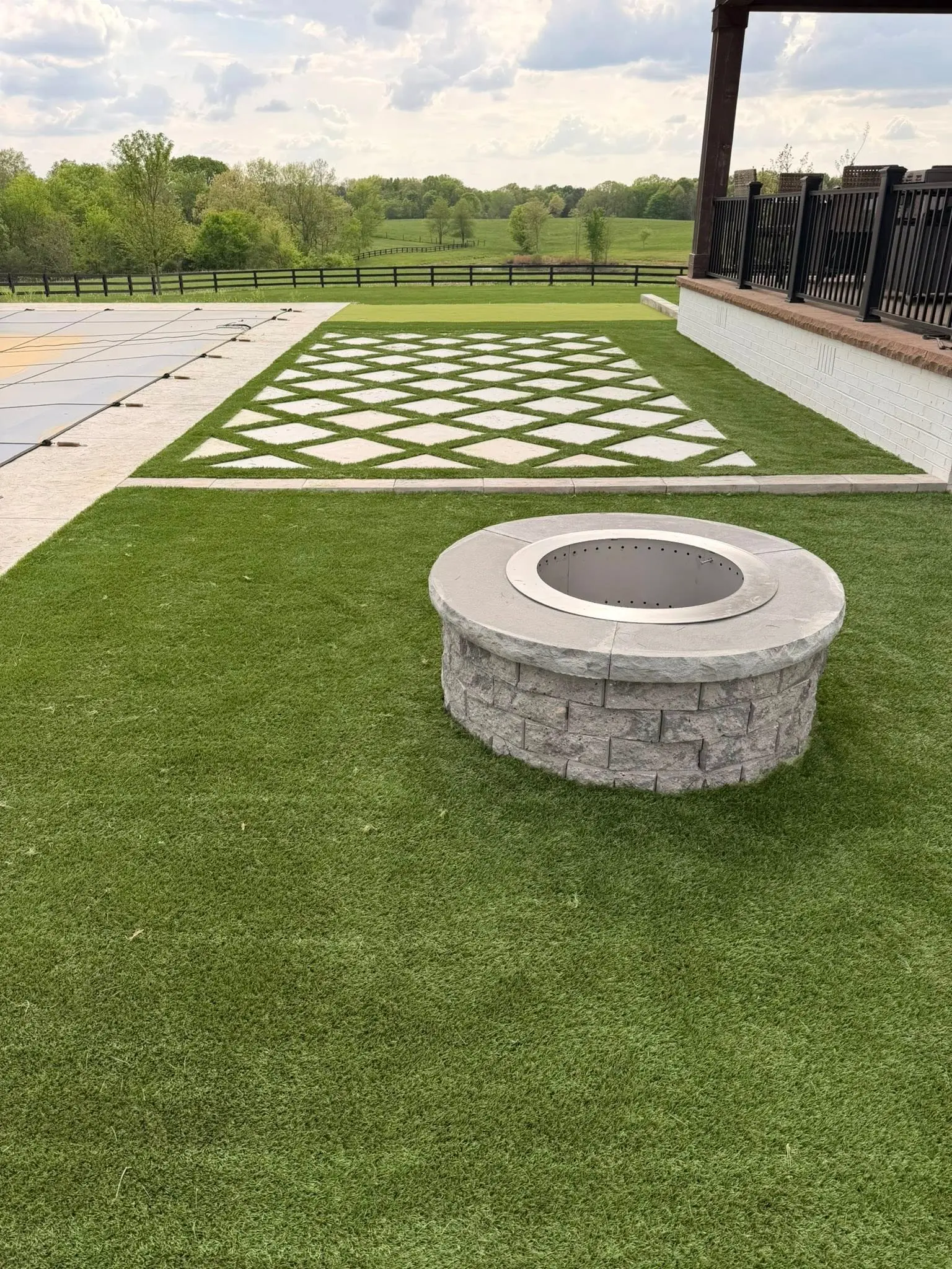 Backyard fire pit with paver lawn inset