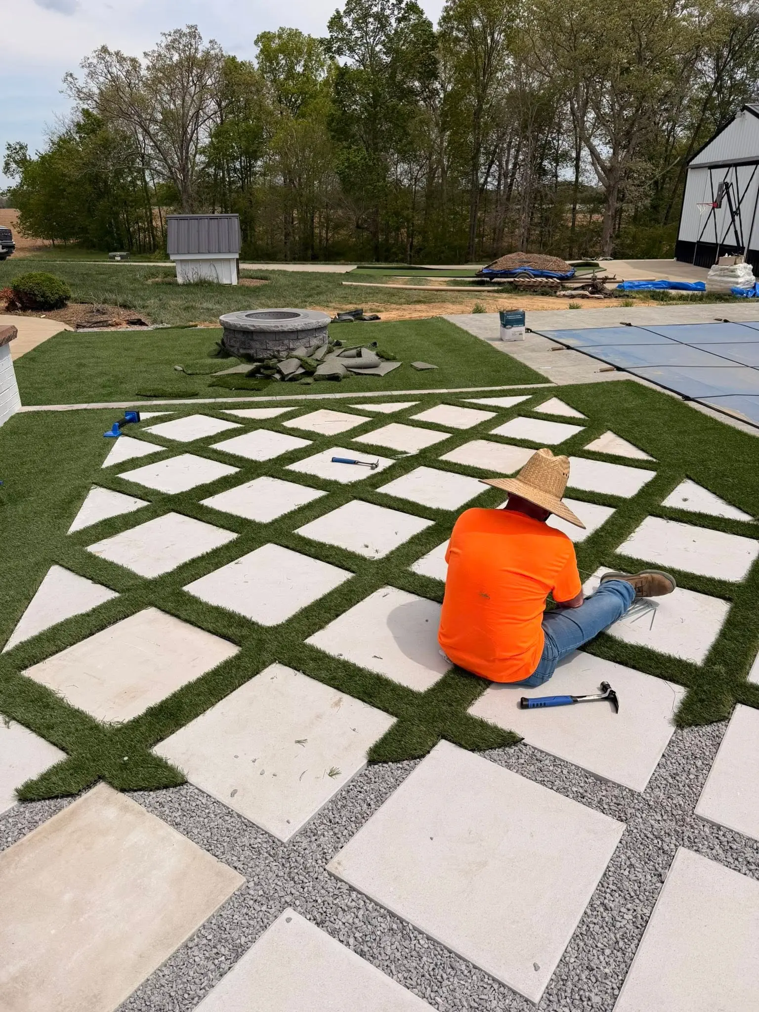 Custom paver patio and outdoor living hardscape installation by The Muscle